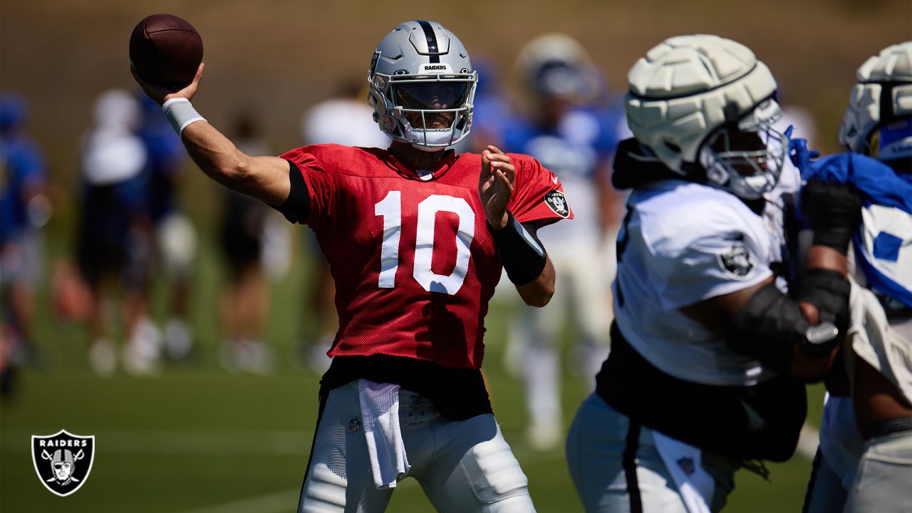 Las Vegas Raiders quarterback Jimmy Garoppolo (10) wipes away