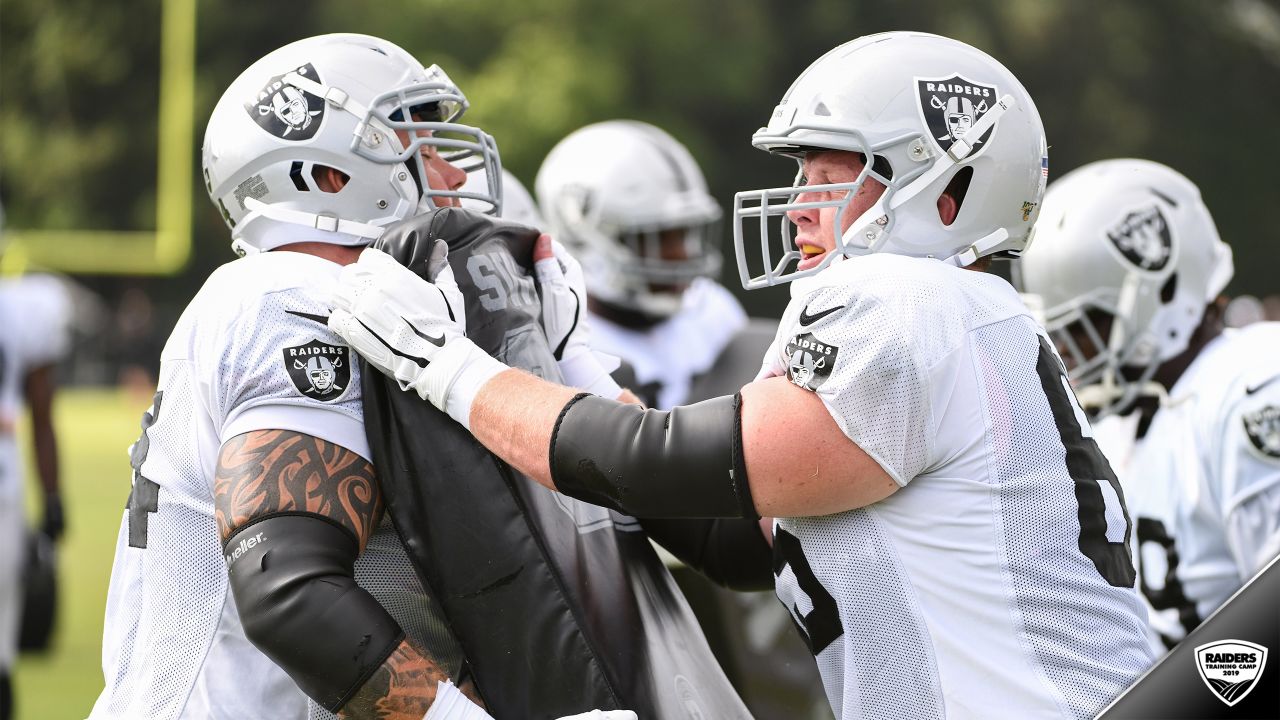 Oakland Raiders offensive guard Jordan Devey (65), center Richie Incognito  (64), and offensive …