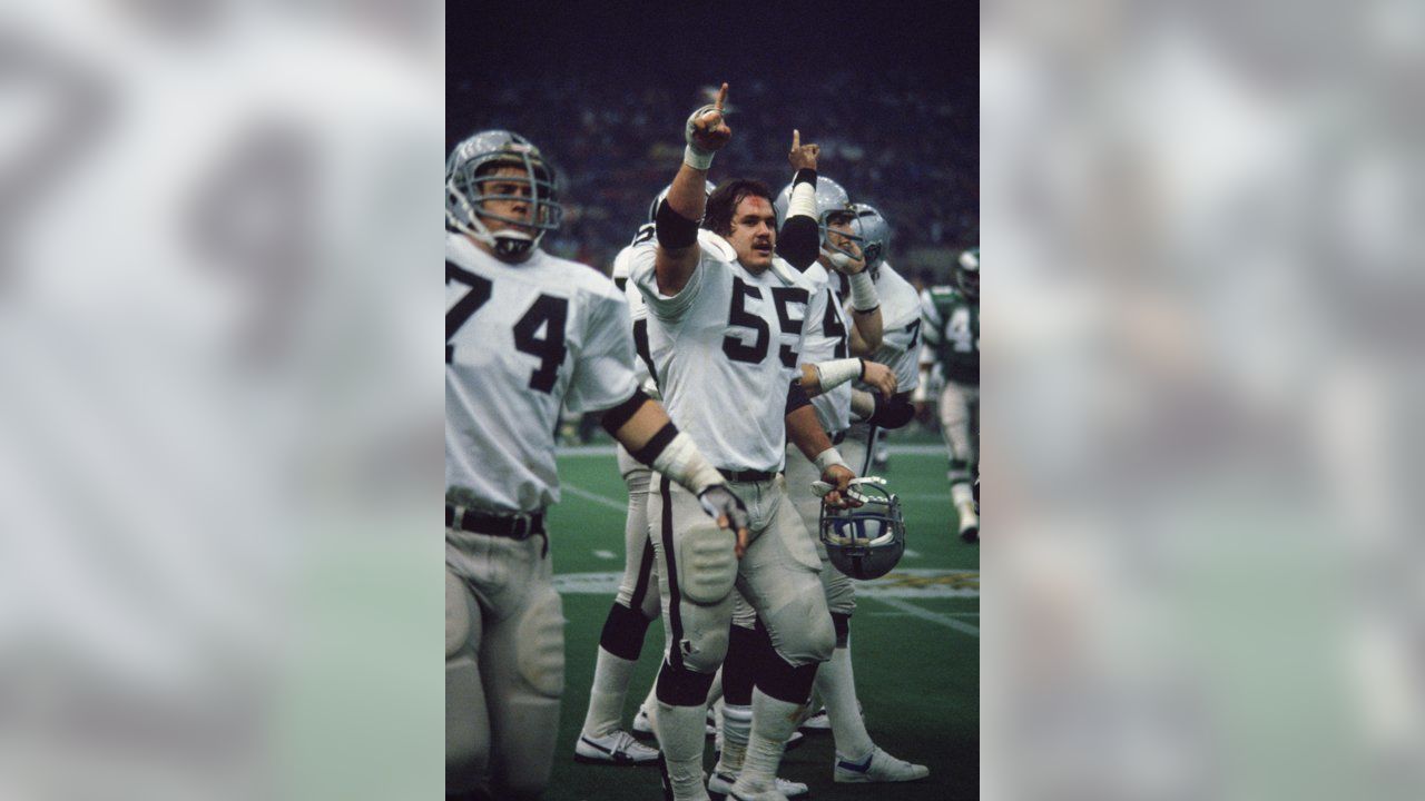 Oakland Raiders quarterback Jim Plunkett takes a snap during the playoff  game between the Cleveland Browns and the Oakland Raiders at Cleveland  Stadium on Jan. 4, 1981. Gene Upshaw is number 63