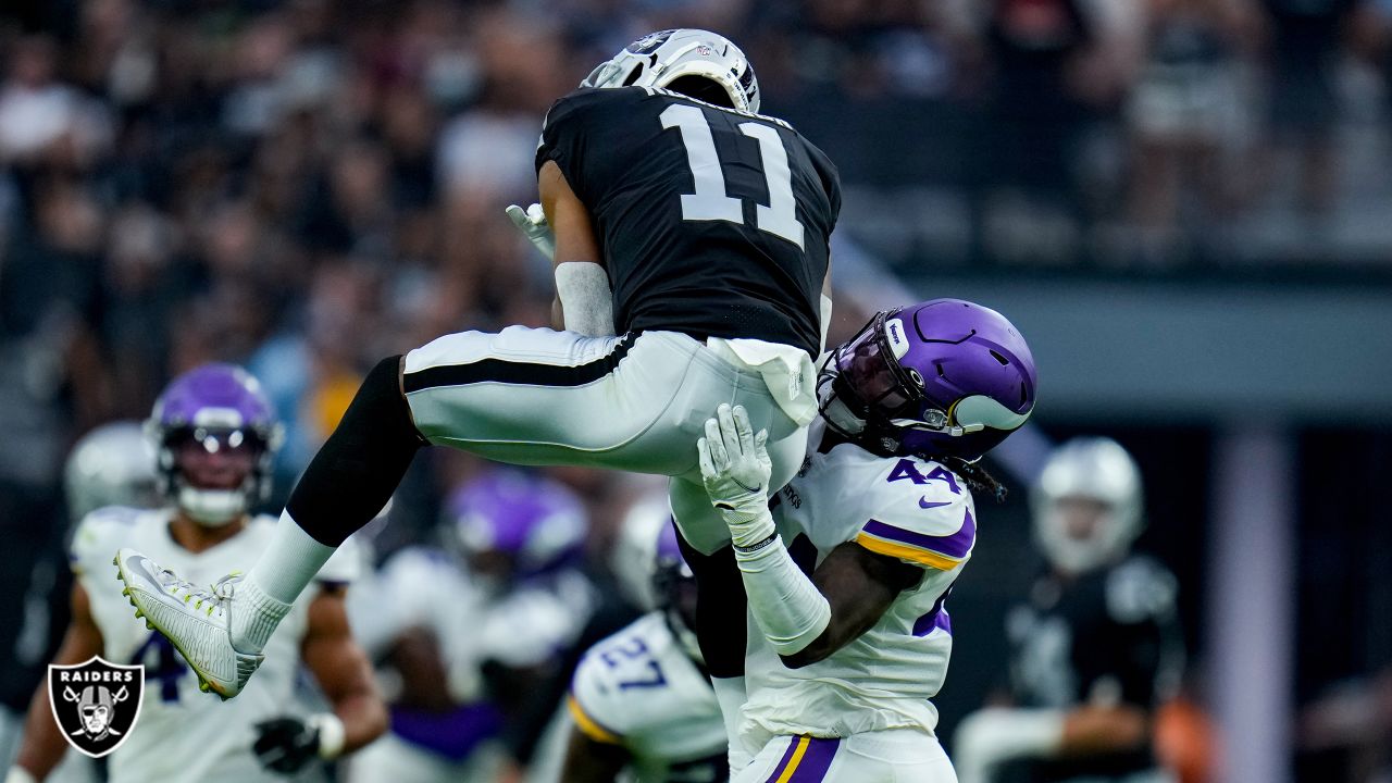 Minnesota Vikings linebacker Luiji Vilain jumps over Las Vegas Raiders  quarterback Jarrett Stidham during the first half of an NFL preseason  football game, Sunday, Aug. 14, 2022, in Las Vegas. (AP Photo/Rick