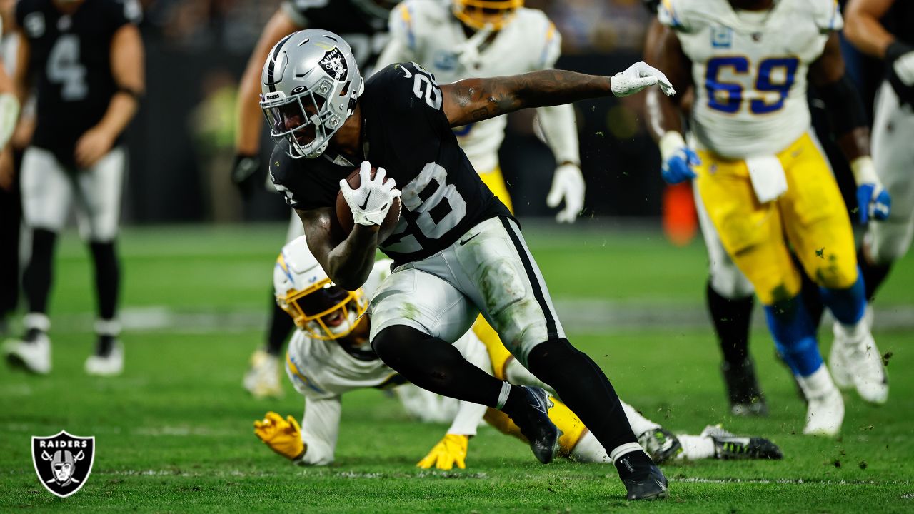 Las Vegas Raiders running back Josh Jacobs (28) gains yards on a run during  an NFL football game against the Los Angeles Chargers, Sunday, September  11, 2022 in Inglewood, Calif. The Chargers