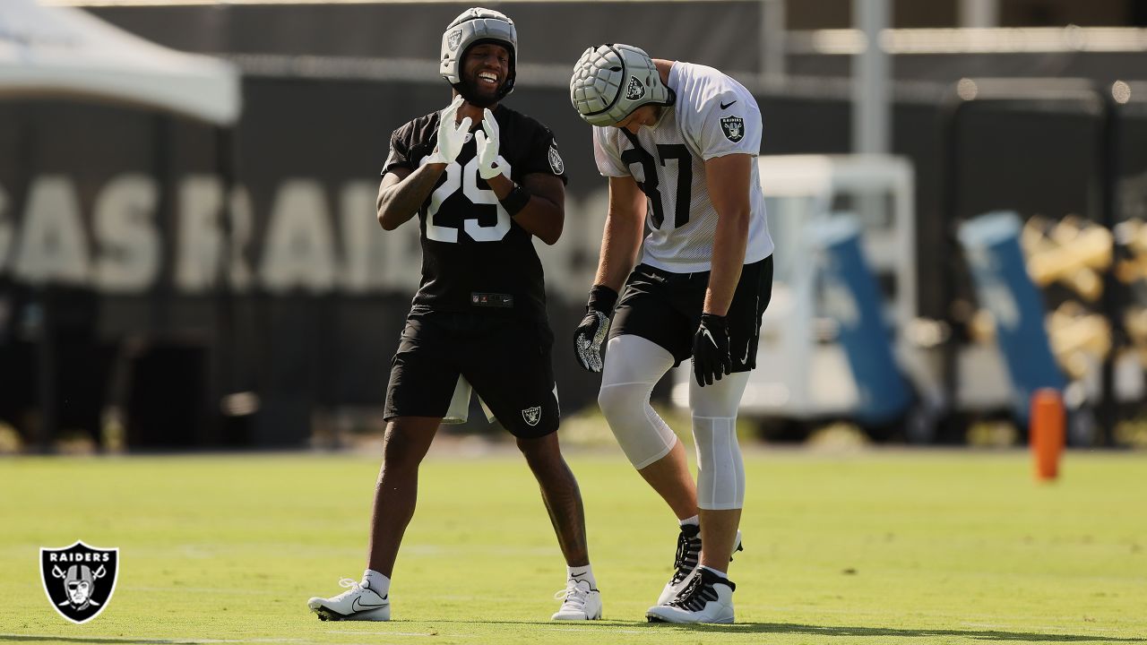 Foster Moreau of the Las Vegas Raiders hugs Henry Ruggs III after