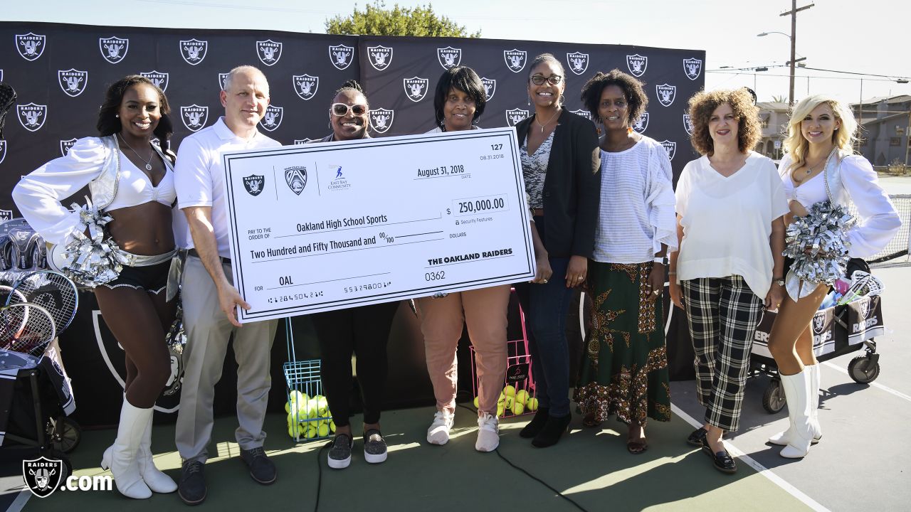 The Oakland Raiders' President Marc Badain, left, his wife Amy and