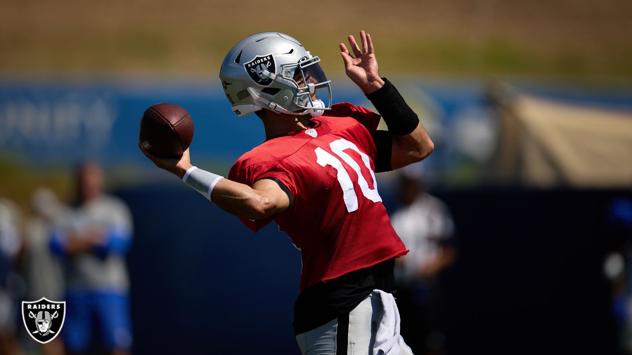 Las Vegas Raiders quarterback Jimmy Garoppolo (10) wipes away