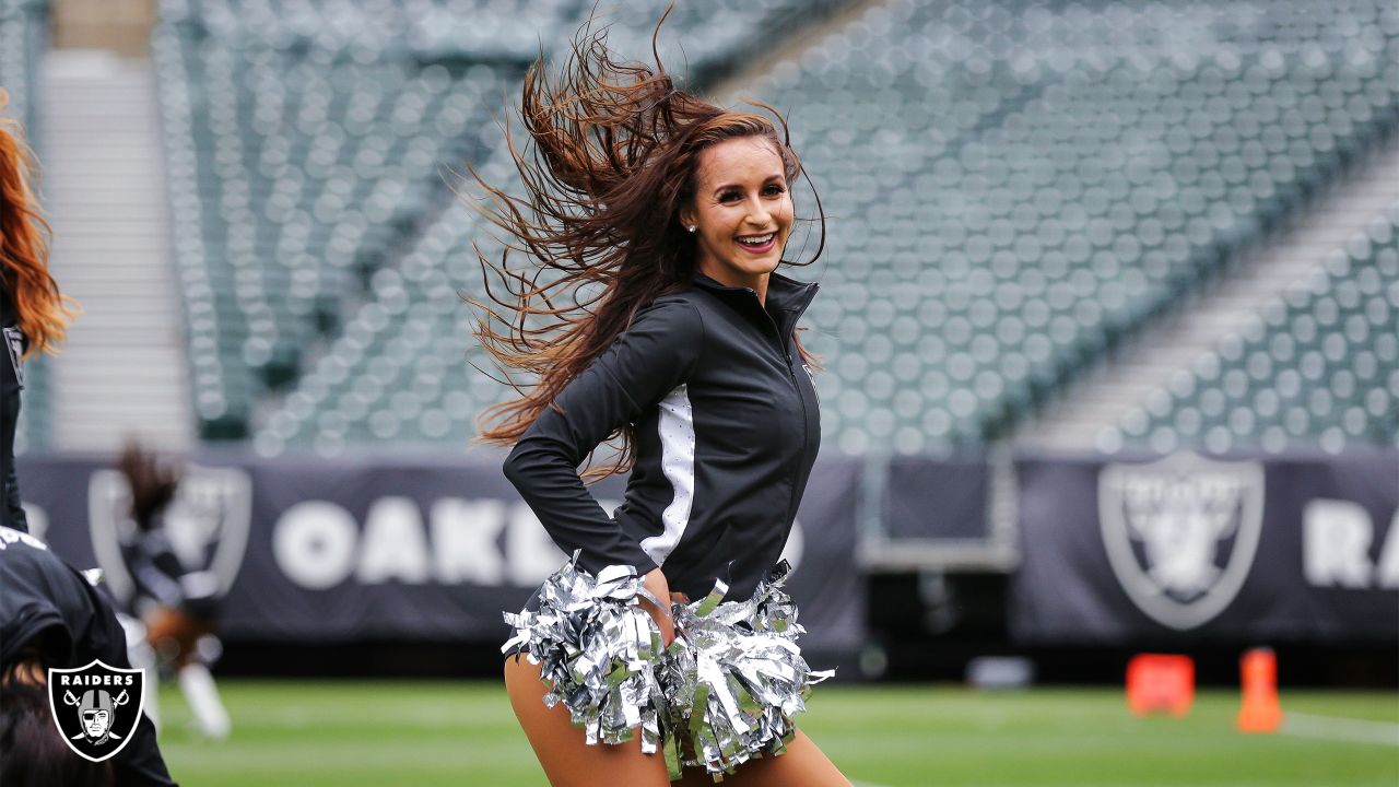 The Raiderettes perform on the field before fans spread throughout the  stands during the 2021 L …