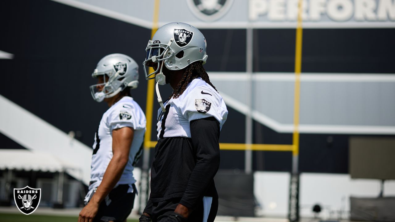 Las Vegas Raiders cornerback Amik Robertson (21) wears a mask while  stretching during a practic …