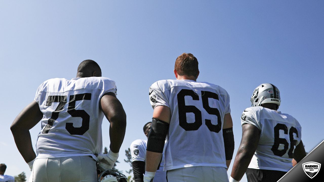 Oakland Raiders offensive guard Jordan Devey (65), center Richie Incognito  (64), and offensive …