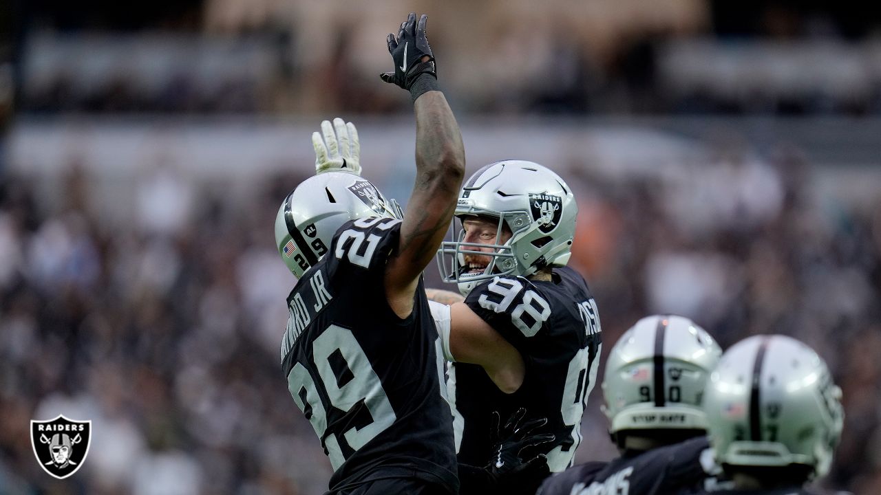 Foster Moreau of the Las Vegas Raiders hugs Henry Ruggs III after