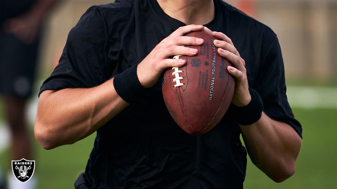 Las Vegas Raiders quarterback Chase Garbers (15) throws the ball on the  field before an NFL