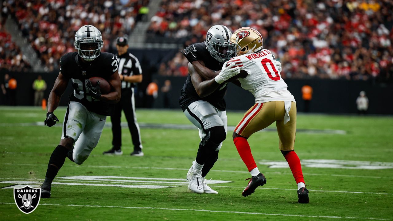 Las Vegas Raiders quarterback Aidan O'Connell (4) hands the ball off to  running back Zamir White (35) in the first half of a preseason NFL football  game against the Dallas Cowboys in