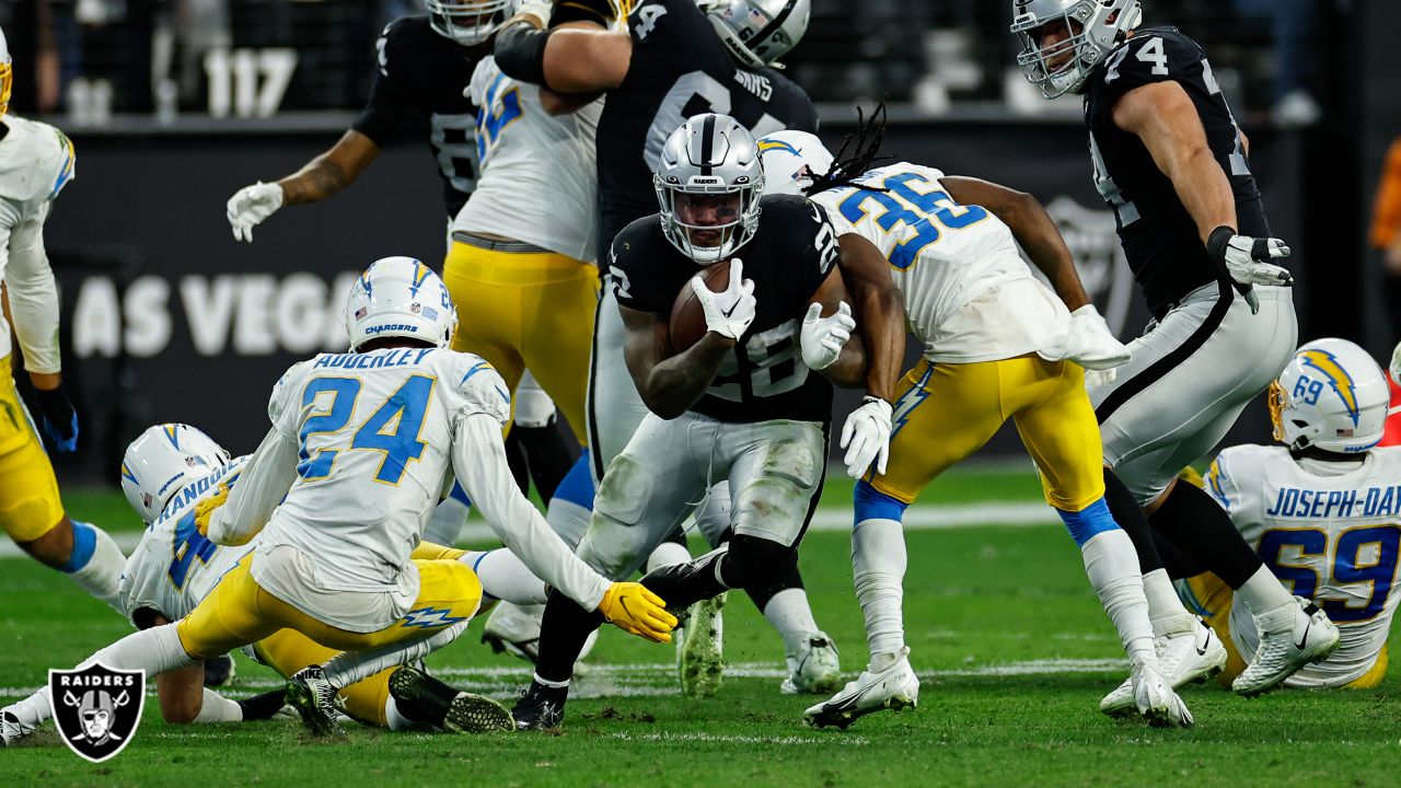 Las Vegas Raiders running back Josh Jacobs (28) gains yards on a run during  an NFL football game against the Los Angeles Chargers, Sunday, September  11, 2022 in Inglewood, Calif. The Chargers