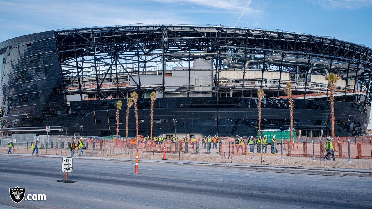 Las Vegas Raiders owner Mark Davis, center, speaks during a news  conference, officially renaming the Oakland Raiders to the Las Vegas Raiders,  in front of Allegiant Stadium in Las Vegas Wednesday, Jan.