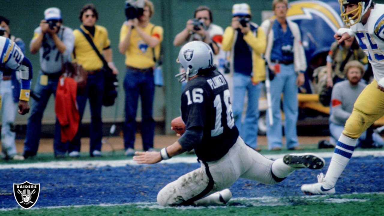 Oakland Raiders quarterback Jim Plunkett takes a snap during the playoff  game between the Cleveland Browns and the Oakland Raiders at Cleveland  Stadium on Jan. 4, 1981. Gene Upshaw is number 63