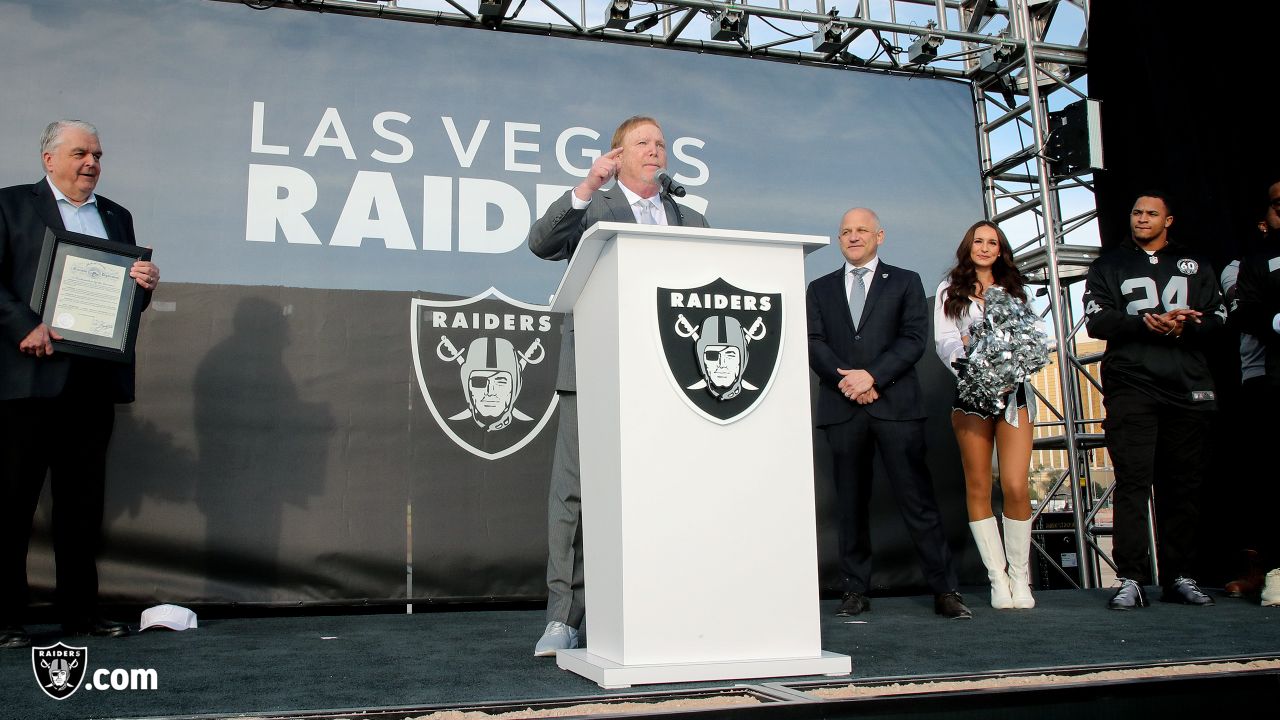 Las Vegas Raiders owner Mark Davis, center, speaks during a news  conference, officially renaming the Oakland Raiders to the Las Vegas Raiders,  in front of Allegiant Stadium in Las Vegas Wednesday, Jan.