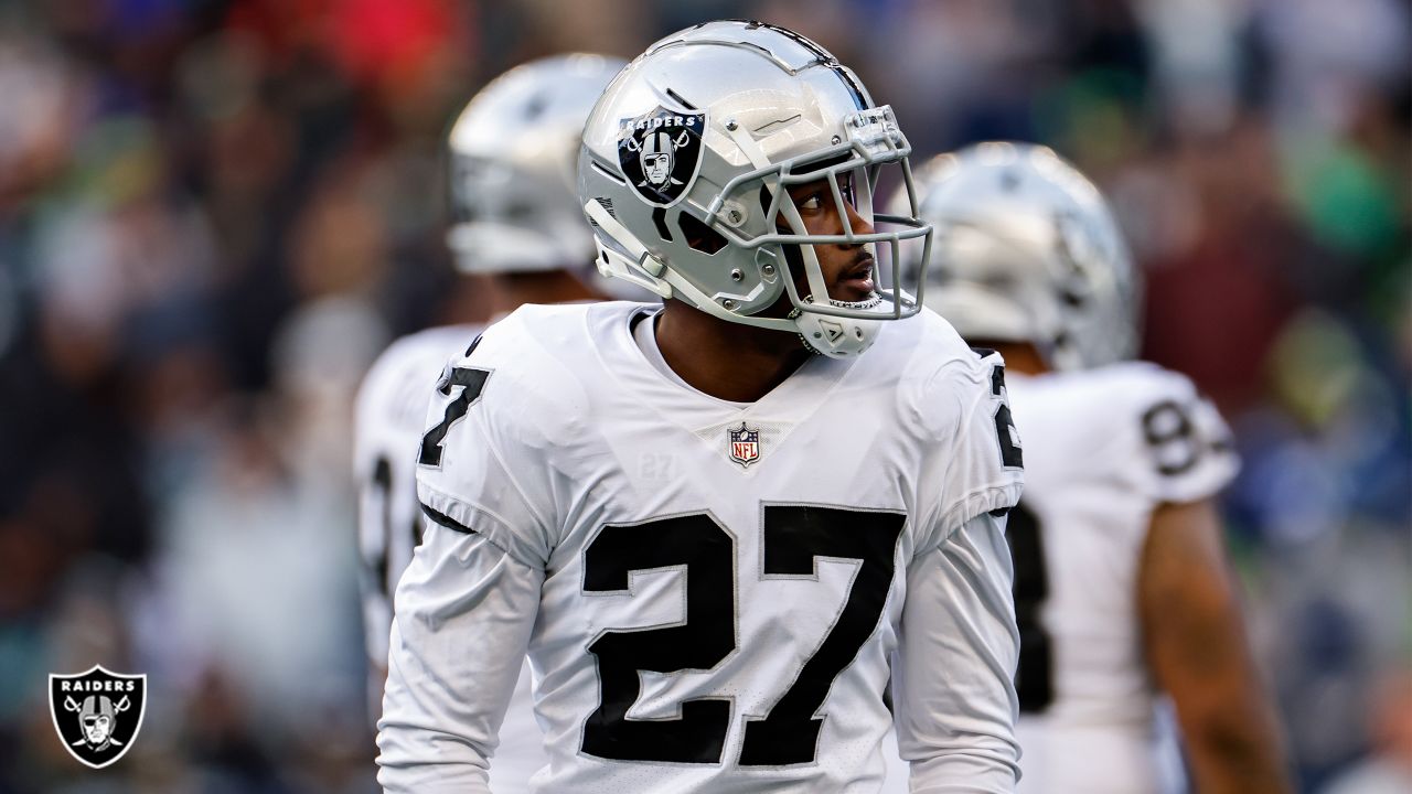 Las Vegas Raiders cornerback Sam Webb (27) tackles Seattle