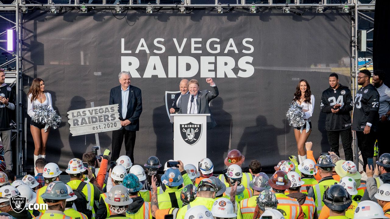 Las Vegas Raiders owner Mark Davis, center, speaks during a news  conference, officially renaming the Oakland Raiders to the Las Vegas Raiders,  in front of Allegiant Stadium in Las Vegas Wednesday, Jan.