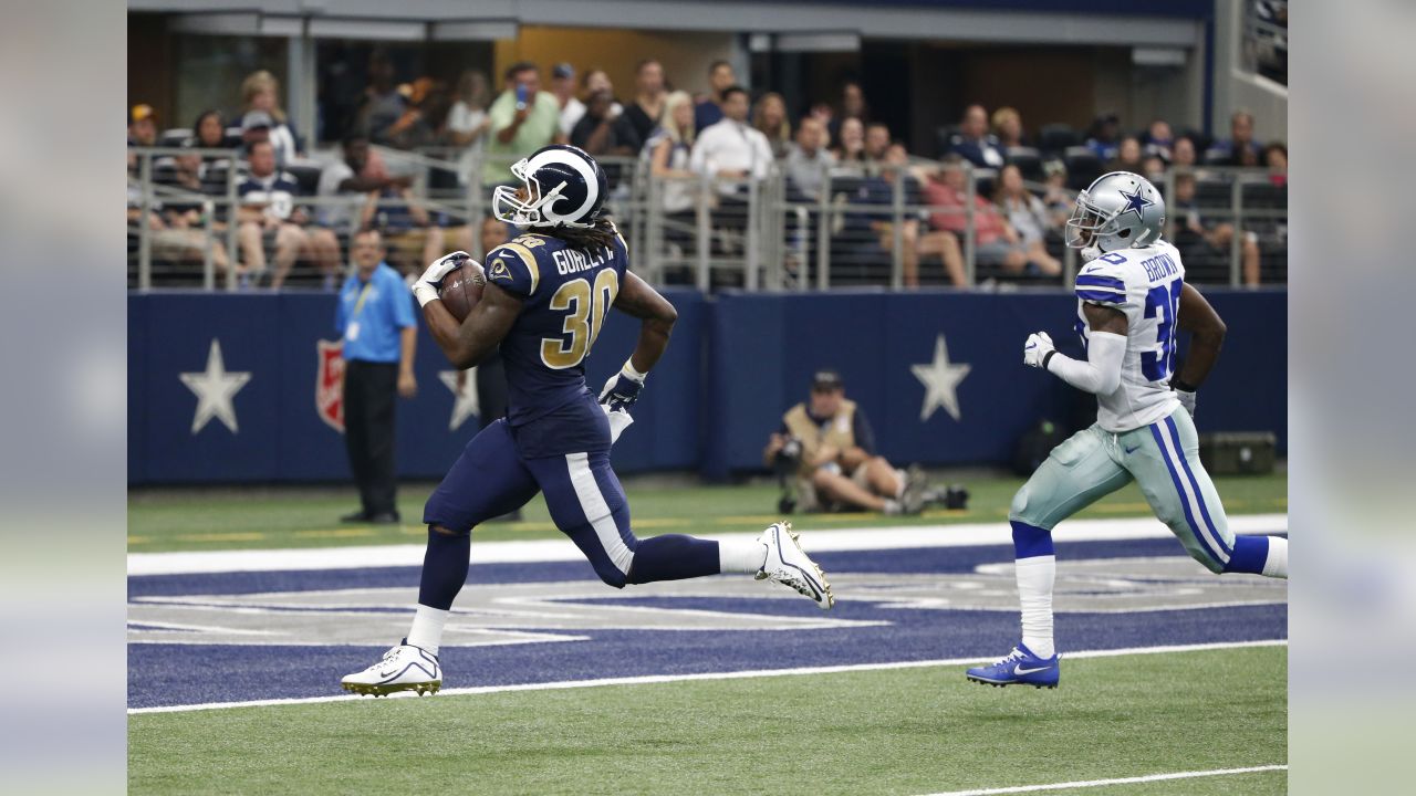 Los Angeles Rams running back Todd Gurley scores past Dallas Cowboys  cornerback Chidobe Awuzie during the first half in an NFL divisional  football playoff game Saturday, Jan. 12, 2019, in Los Ange …