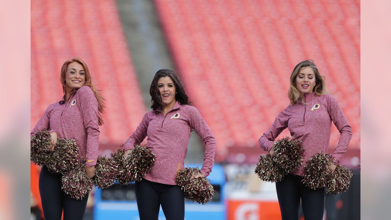 Fans cheer as teams warm up before an NFL wild-card football game