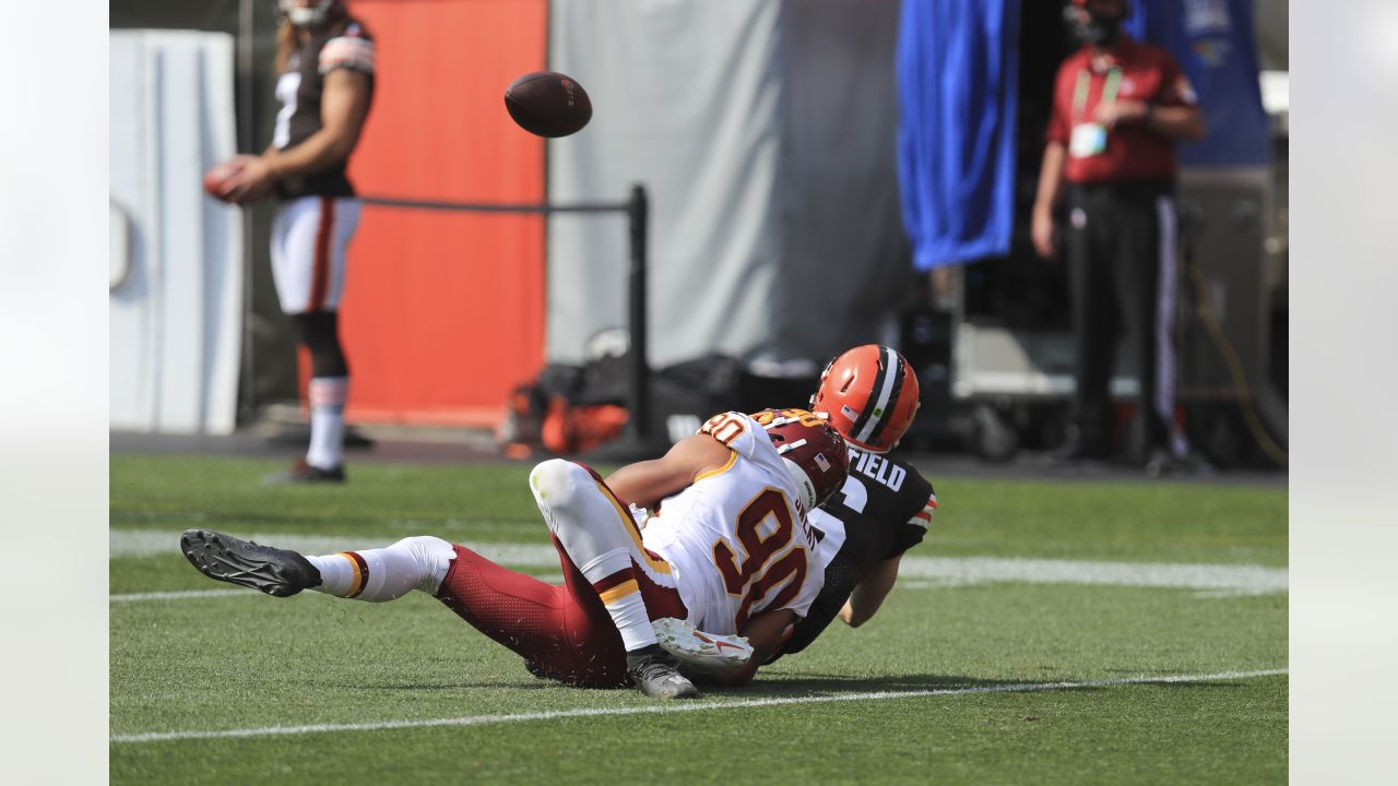 Washington Commanders defensive end Montez Sweat (90) looks across the line  of scrimmage alongside safety Kamren Curl in the second half of an NFL  football game against the Atlanta Falcons, Sunday, Nov.