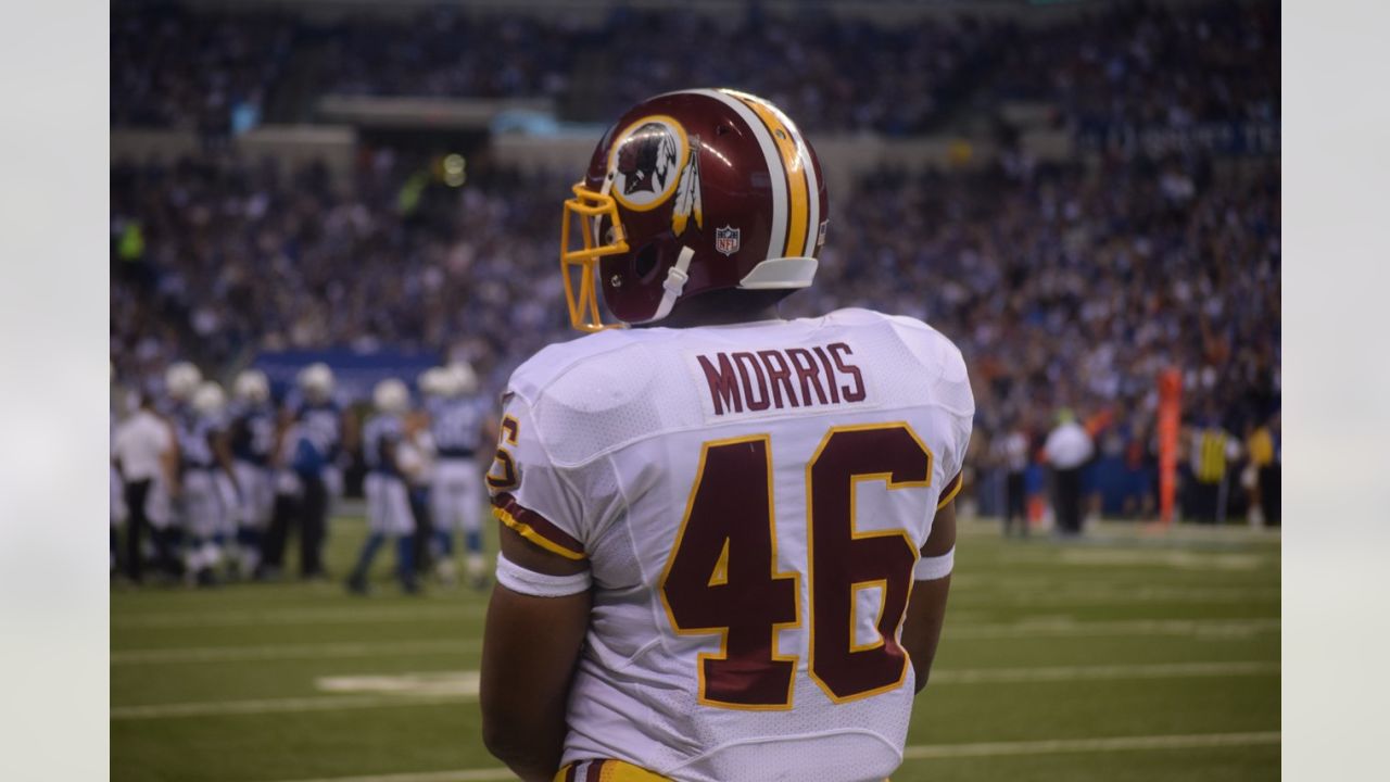 Washington Redskins Clinton Portis (R) carries the ball 3 yards as Dallas  Cowboys Roy Williams (31)