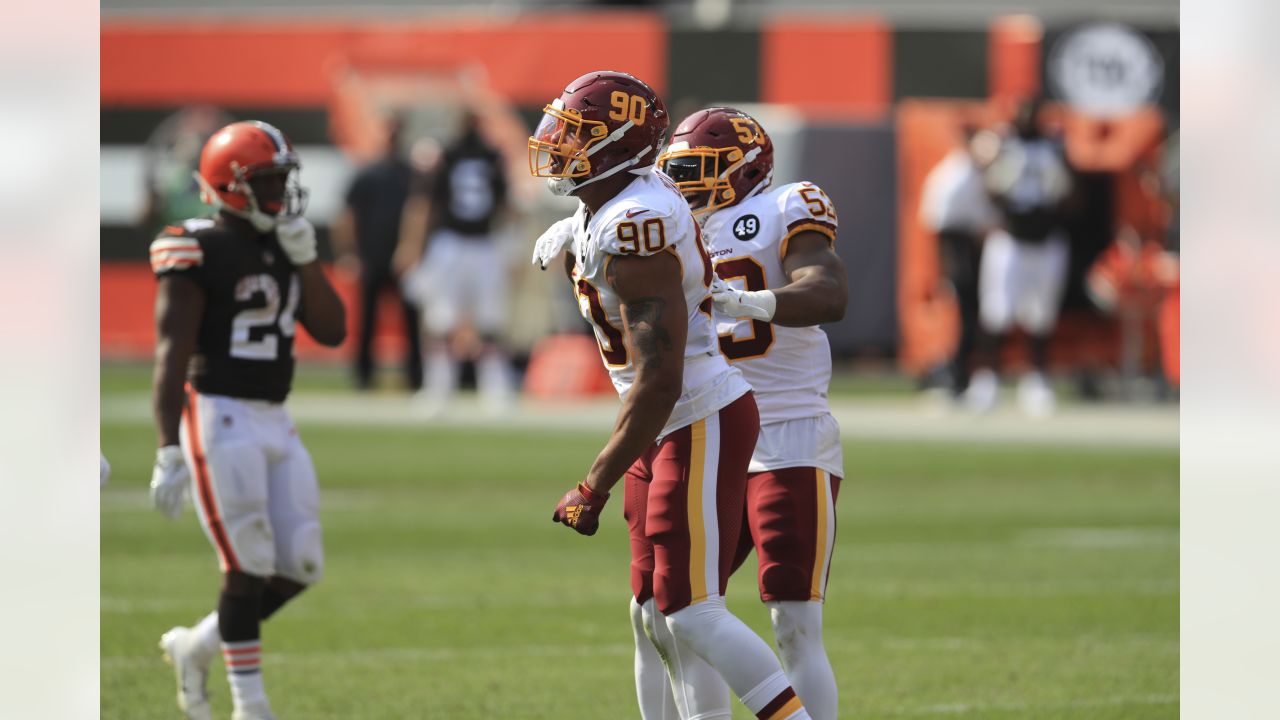 Washington Commanders defensive end Montez Sweat (90) looks across the line  of scrimmage alongside safety Kamren Curl in the second half of an NFL  football game against the Atlanta Falcons, Sunday, Nov.