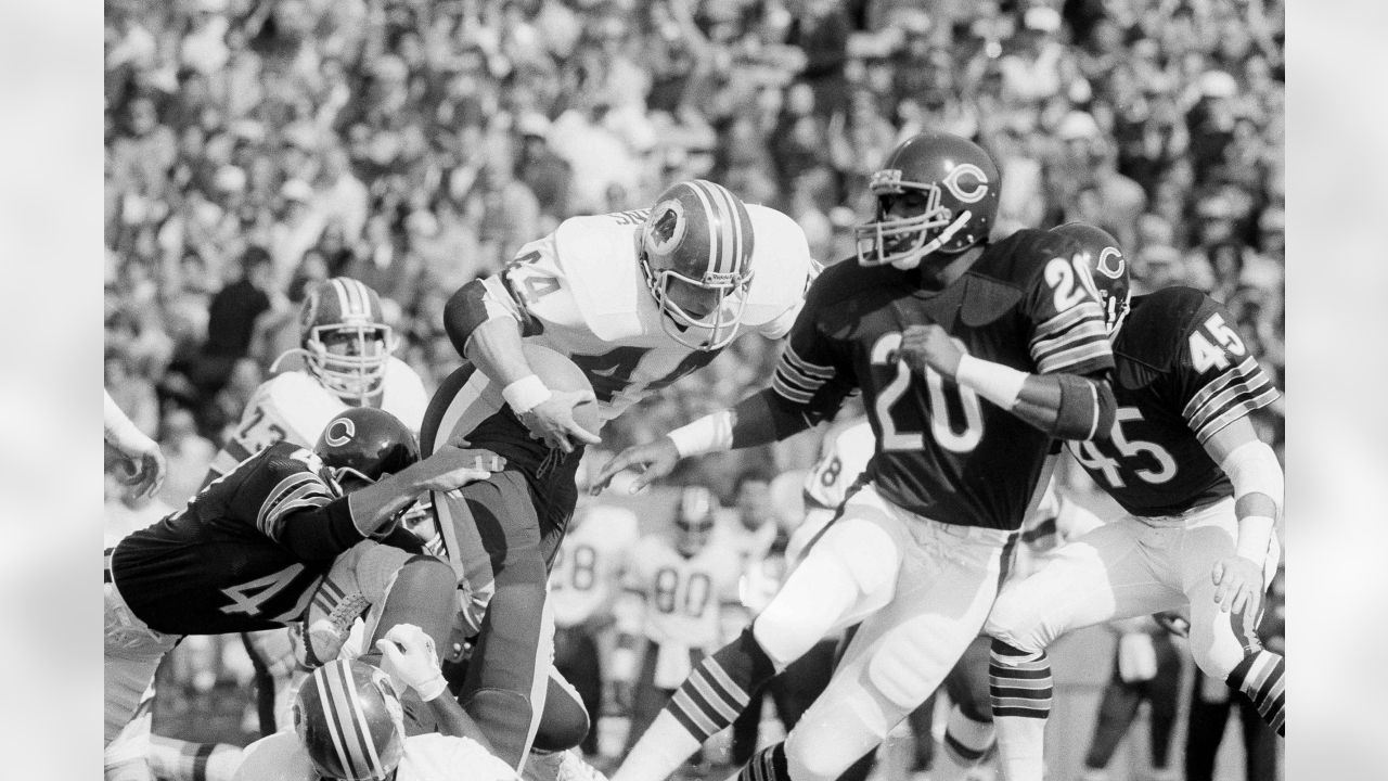 Washington Redskins John Riggins (44) hits the line for a gain in