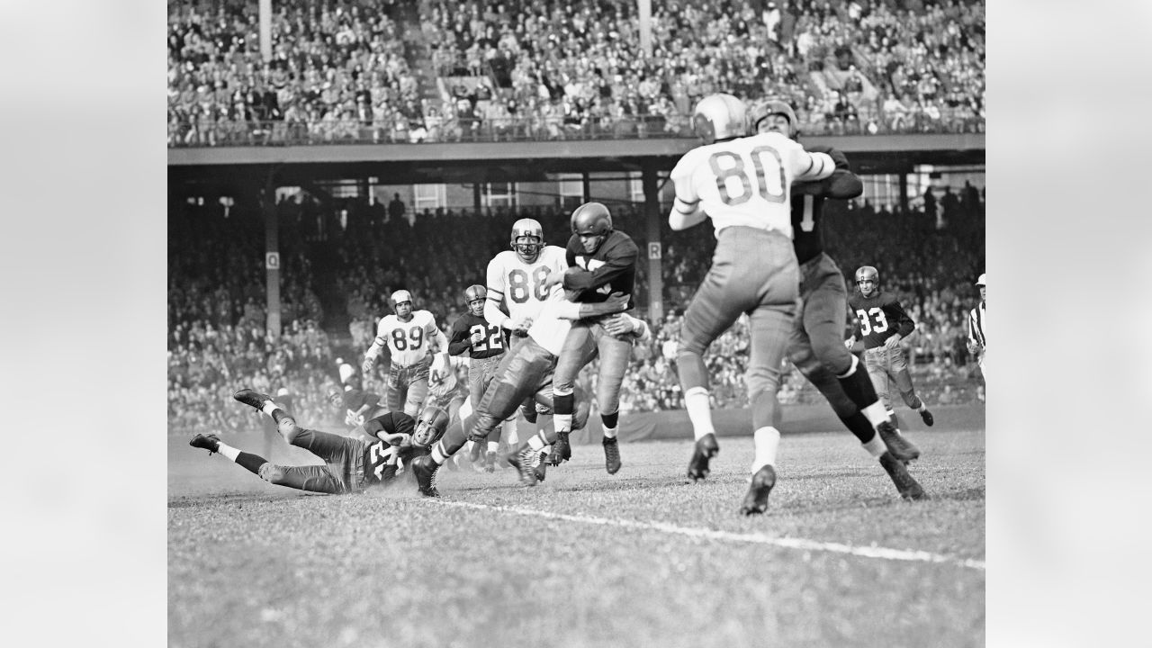 Bill Dudley (35) Washington halfback, eludes a tackle by Philadelphia Eagles  end Norm Willey for a short gain in the second period of the Redskins-Eagles  National Football League game Oct. 28, 1951