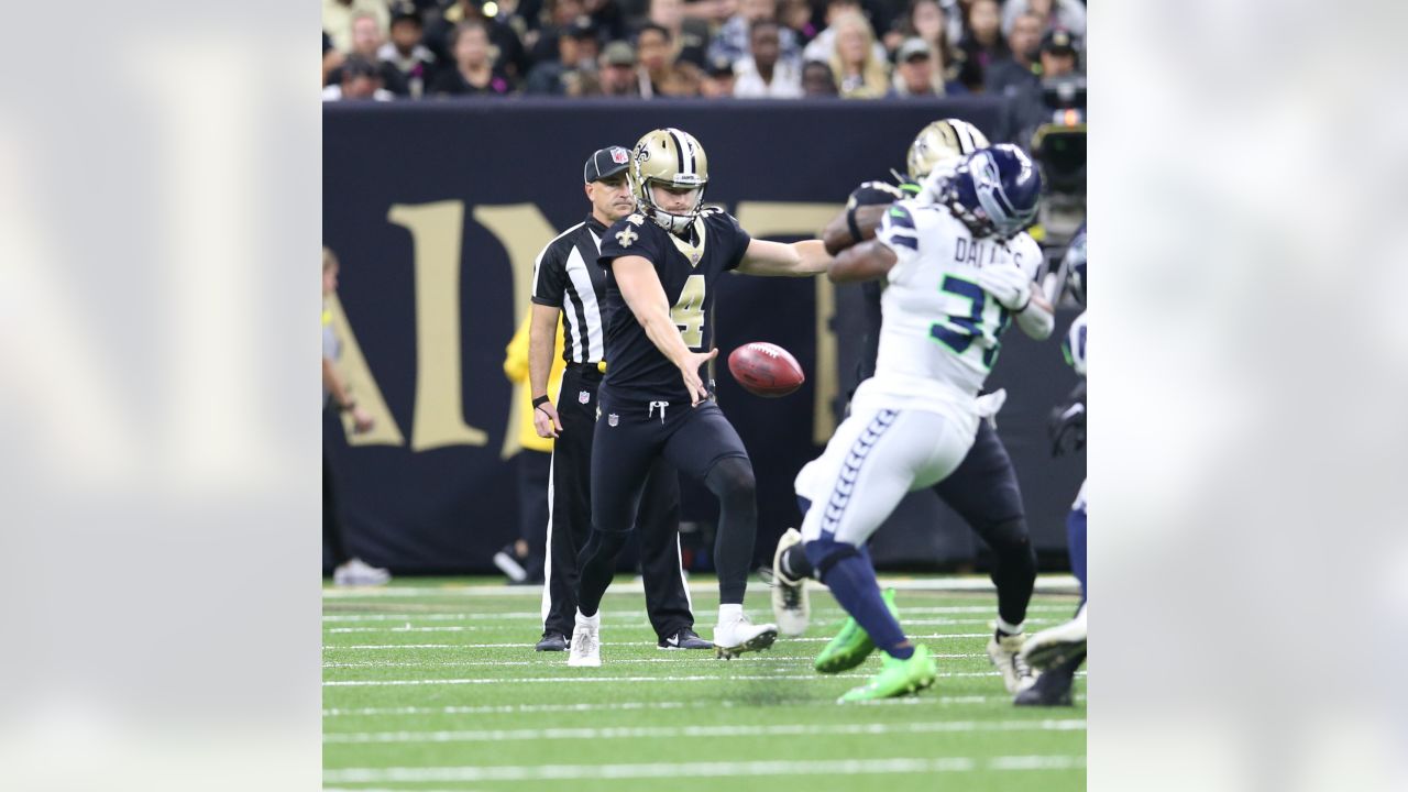 The referee performs the coin toss before an NFL football game between the  New Orleans Saints and the Seattle Seahawks in New Orleans, Sunday, Oct. 9,  2022. The Saints won 39-32. (AP