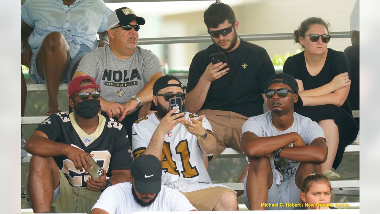 A New Orleans Saints fan waits for the start of practice during the Back  Together Weekend fan appreciation initiative at the NFL team's football  training camp in Metairie, La., Saturday, July 29