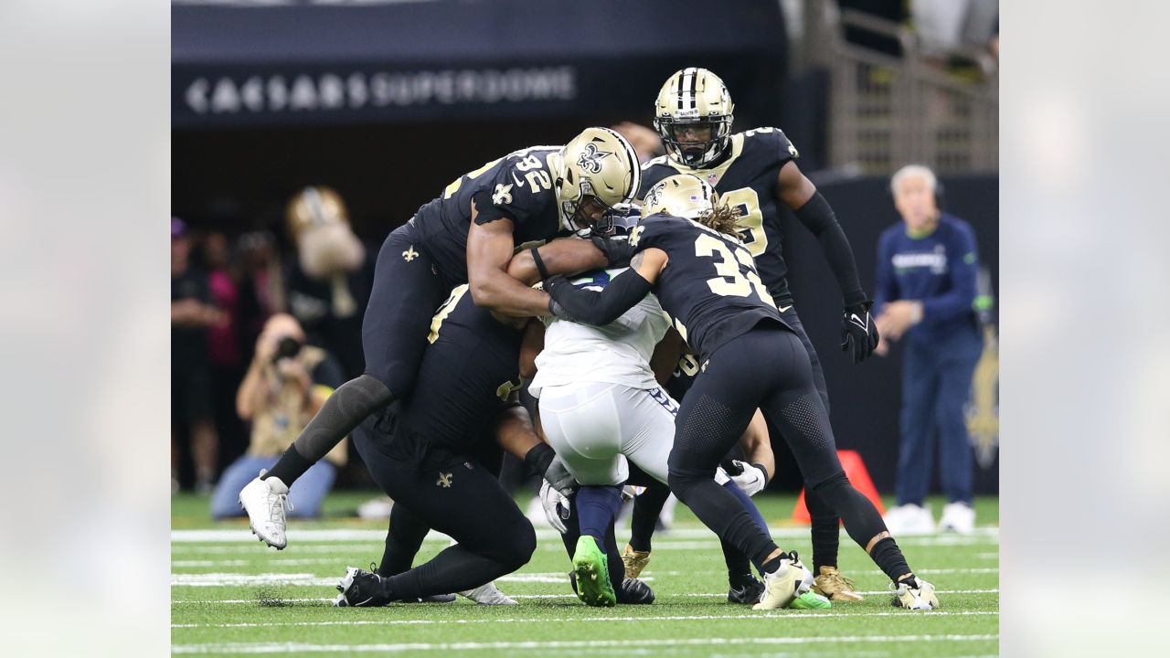 The referee performs the coin toss before an NFL football game between the  New Orleans Saints and the Seattle Seahawks in New Orleans, Sunday, Oct. 9,  2022. The Saints won 39-32. (AP