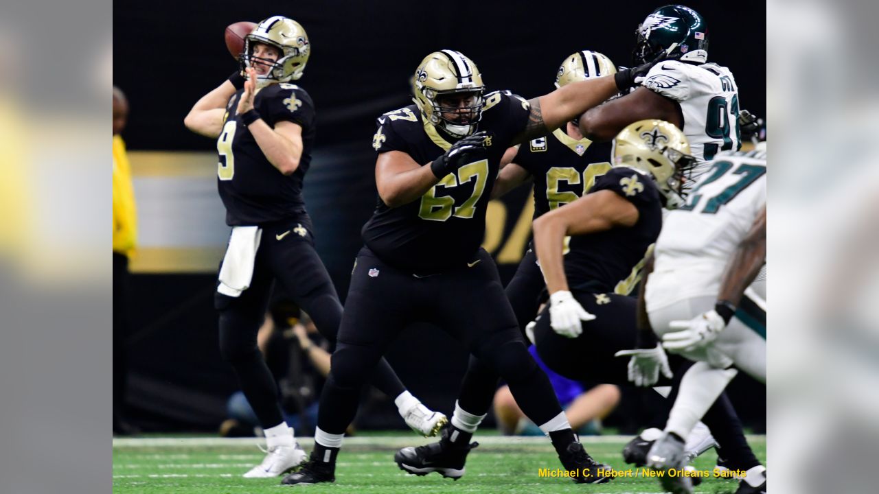 Taysom Hill New Orleans Saints Unsigned Carries the Ball in Black Jersey  Photograph