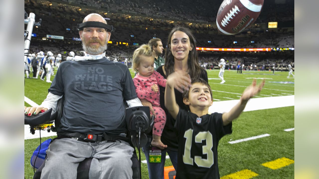 Former New Orleans Saints Steve Gleason, left, poses for a photo with Saints  owner Gayle Benson, right, Steve's children, Rivers, 11, Gray, 4, and an  unidentified member of Team Gleason, before an