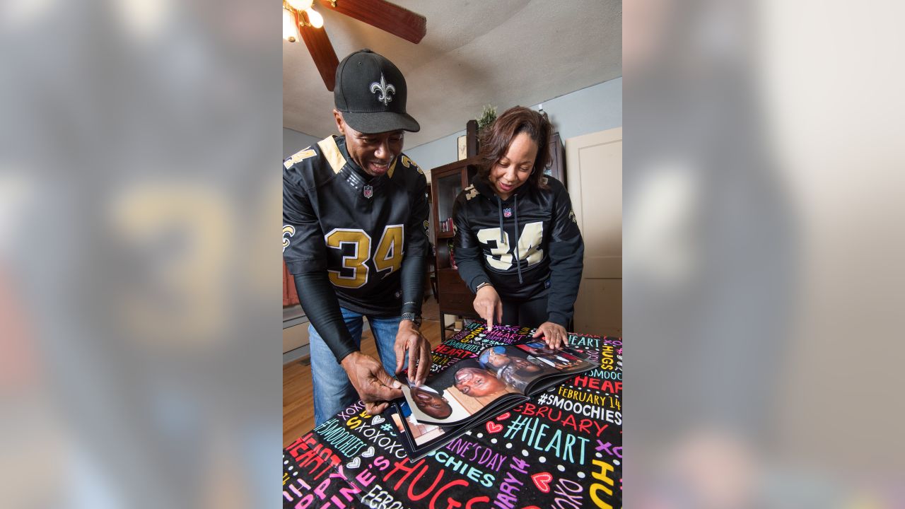 Arthur Hardee and Felicia Jordan look at a photo book from Justin Hardee's college days.