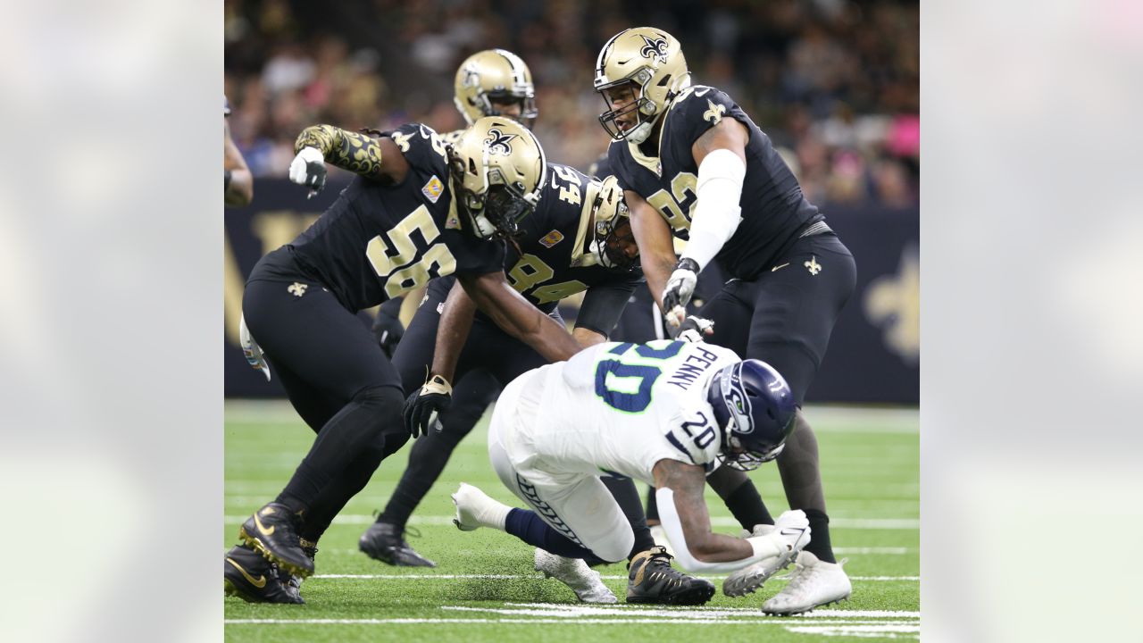 The referee performs the coin toss before an NFL football game between the  New Orleans Saints and the Seattle Seahawks in New Orleans, Sunday, Oct. 9,  2022. The Saints won 39-32. (AP