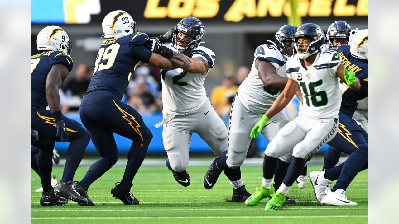 Los Angeles Chargers quarterback Justin Herbert (10) adjusts his helmet as  he warms up before an NFL football game against the Seattle Seahawks  Sunday, Oct. 23, 2022, in Inglewood, Calif. (AP Photo/Marcio