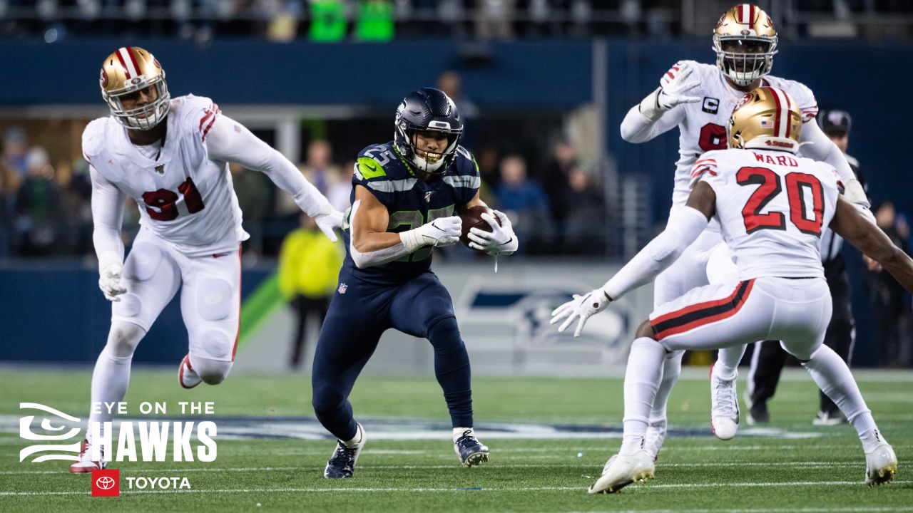 Travis Homer of the Seattle Seahawks runs with the ball in the second