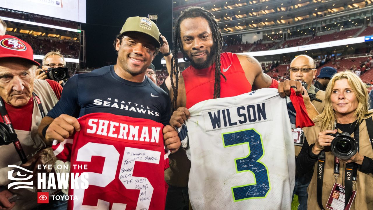 San Francisco 49ers cornerback Richard Sherman (25) is greeted by teammates  after Sherman inter …