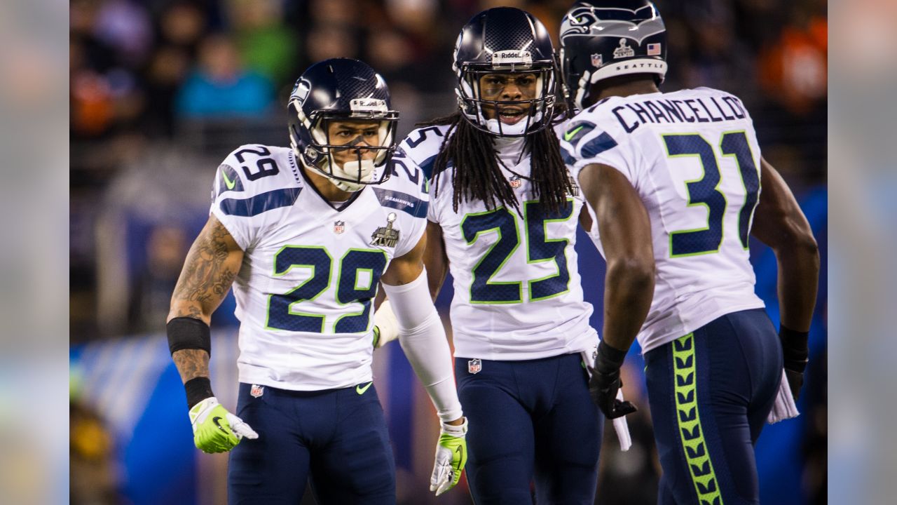 Seattle Seahawks head coach Pete Carroll talks things over with cornerback  Richard Sherman (25) while on the sidelines during the Super Bowl XLVIII at  MetLife Stadium in East Rutherford, New Jersey on