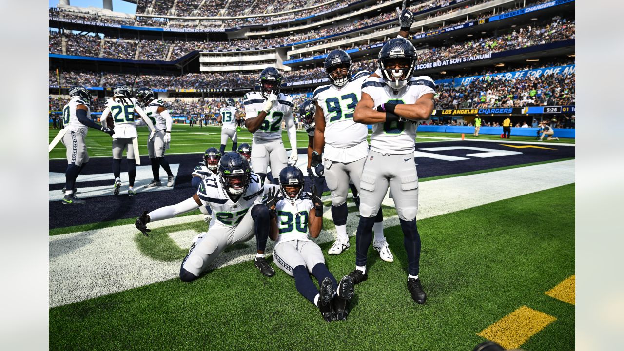 Los Angeles Chargers quarterback Justin Herbert (10) adjusts his helmet as  he warms up before an NFL football game against the Seattle Seahawks  Sunday, Oct. 23, 2022, in Inglewood, Calif. (AP Photo/Marcio