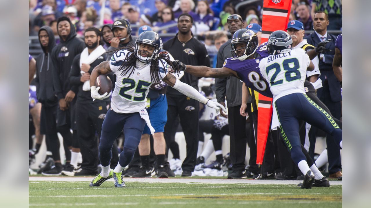 Seattle Seahawks cornerback Richard Sherman (25) and outside linebacker  K.J. Wright (50) team up to tackle Arizona Cardinals running back David  Johnson (31) at CenturyLink Field in Seattle, Washington on December 24