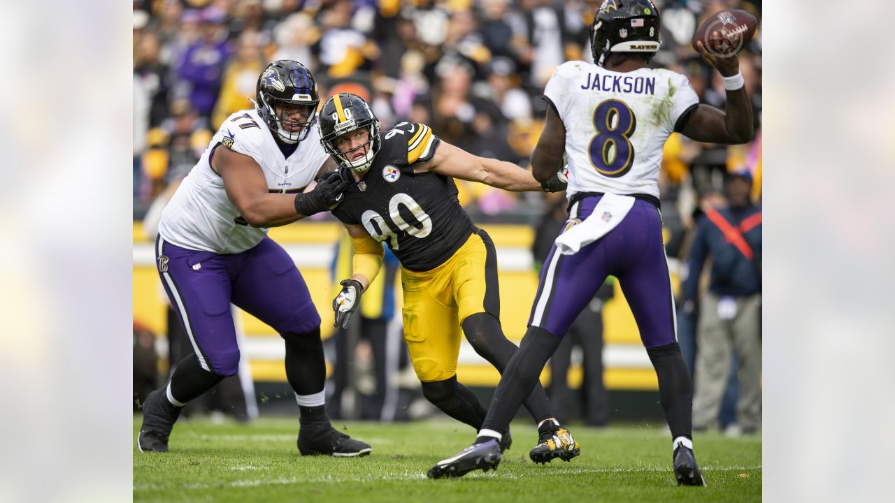 Baltimore Ravens quarterback Lamar Jackson (8) throws the ball as he is hit  by Minnesota Vikings defensive tackle Armon Watts (96) during the second  half of an NFL football game, Sunday, Nov.