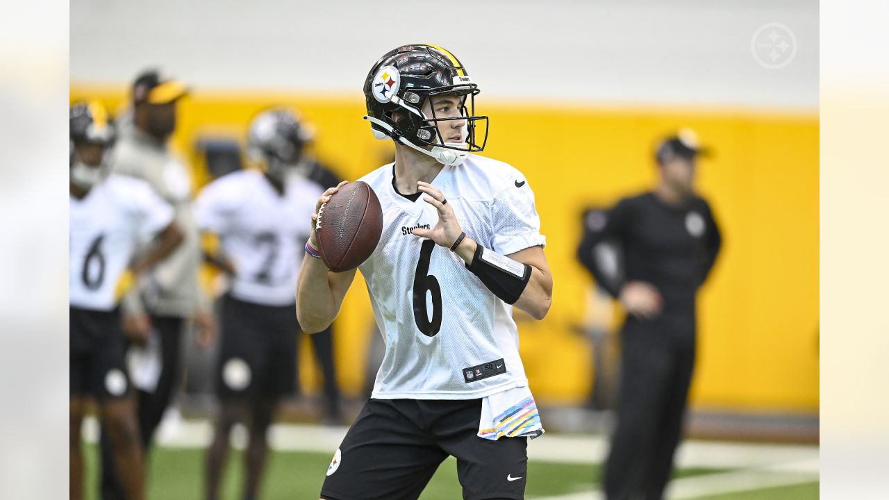 Tanner Morgan of the Pittsburgh Steelers hands off during a