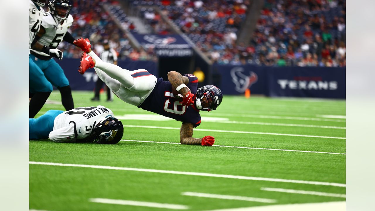 Houston, Texas, USA. 1st Jan, 2023. Jacksonville Jaguars running back  JaMycal Hasty (22) carries the ball while being tackled by Houston Texans  linebacker Christian Harris (48) during the game between the Houston