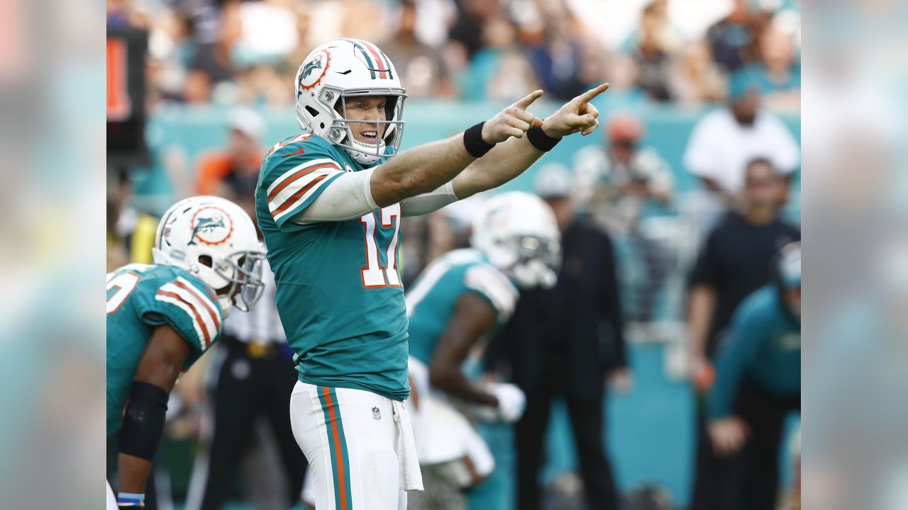 FILE - In this Oct. 14, 2018, file photo, injured Miami Dolphins  quarterback Ryan Tannehill cheers his team during the second half of an NFL  football game against the Chicago Bears, in