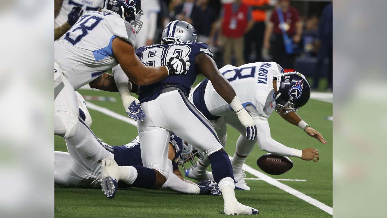 November 05, 2018:.Tennessee Titans quarterback Marcus Mariota (8)  scrambles for a first down during an NFL football game between the  Tennessee Titans and Dallas Cowboys at AT&T Stadium in Arlington, Texas.  Manny