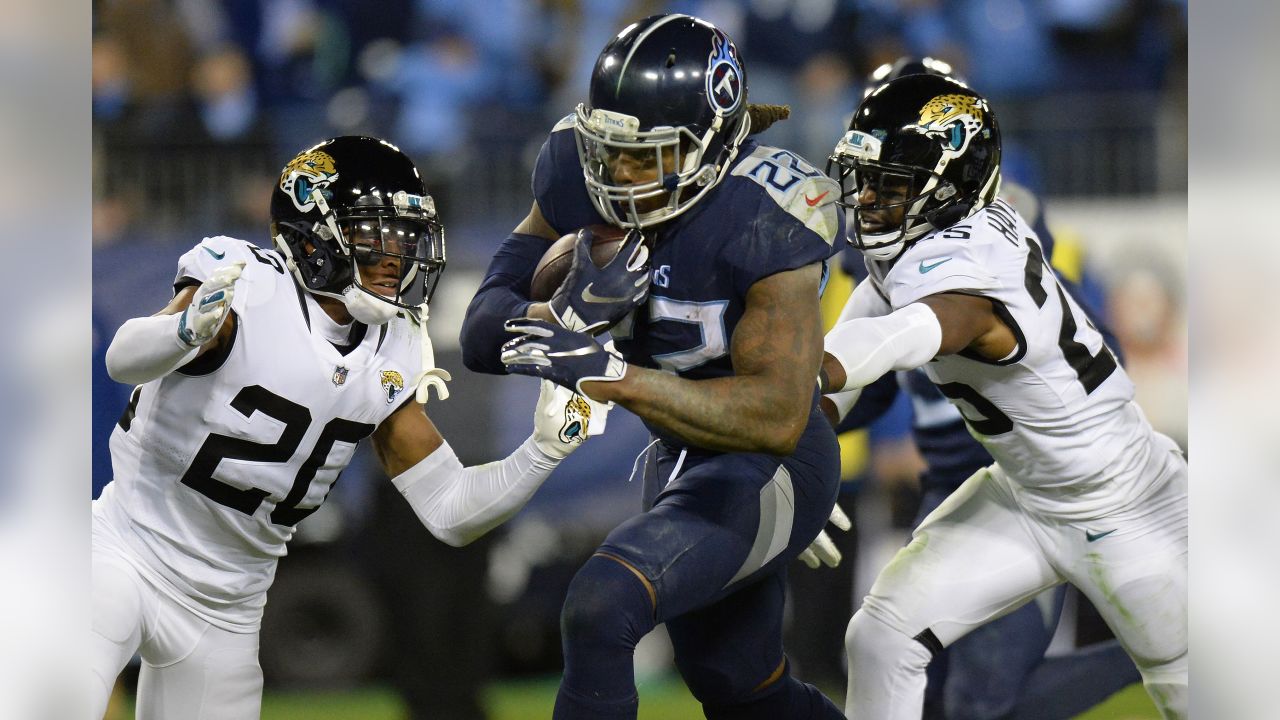 Baltimore Ravens quarterback Anthony Brown (12) runs with the ball as  Tennessee Titans linebacker Jack Gibbens (50) tries to stop him during the  second half of a preseason NFL football game, Thursday