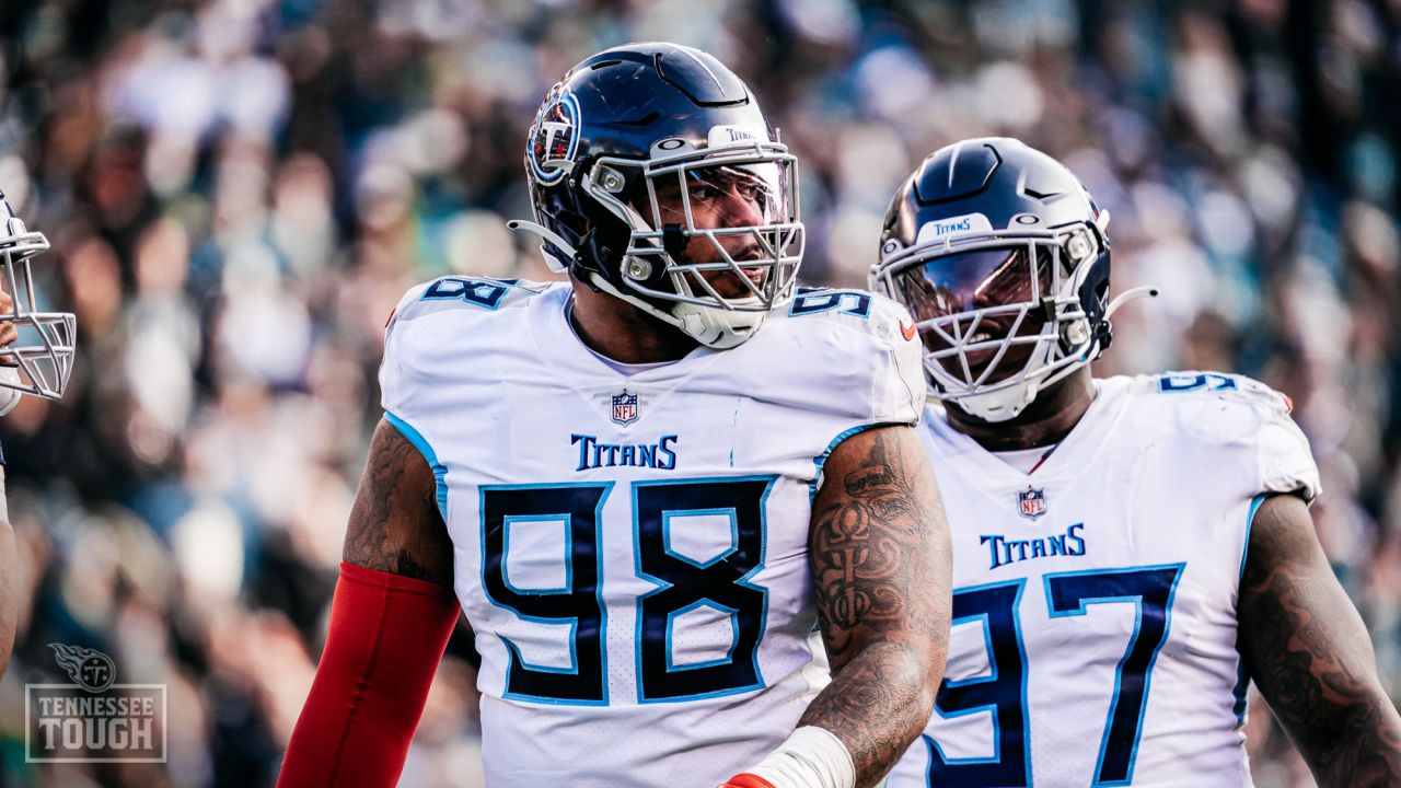 Tennessee Titans defensive tackle Jeffery Simmons (98) and linebacker  Rashad Weaver (99) talk before play starts