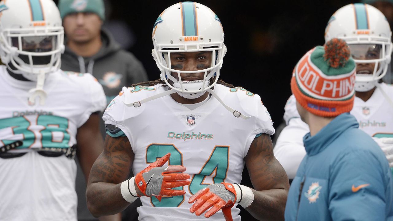 Miami Dolphins running back Senorise Perry (34) walks back to the