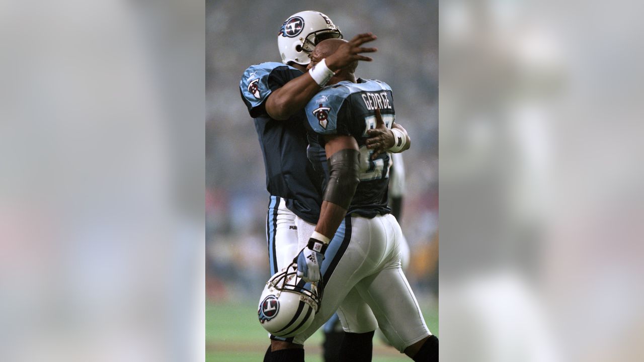 Former Tennessee Titans running back Eddie George, second from left, stands  with family members of the late Titans quarterback Steve McNair, as the  numbers for George and McNair are retired during halftime