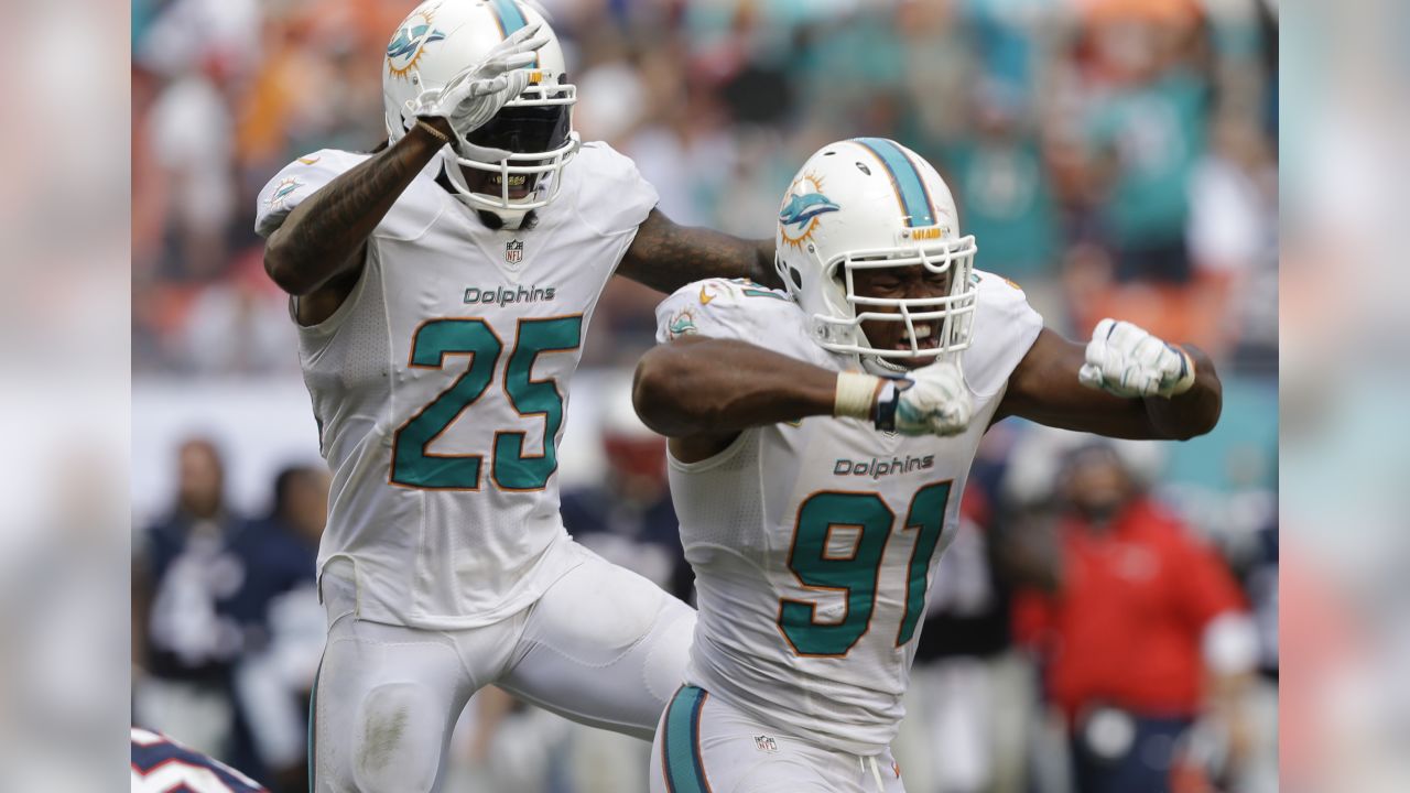 New England Patriots quarterback Tom Brady is sacked for a loss by Miami  Dolphins Koa Misi in second half action against the Miami Dolphins at Sun  Life Stadium in Miami on October